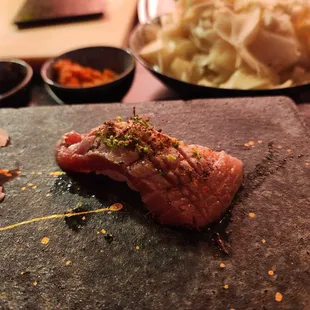 a piece of meat on a stone slab