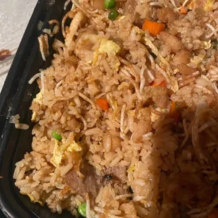 a tray of fried rice and vegetables