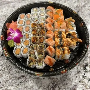 a plate of sushi and vegetables