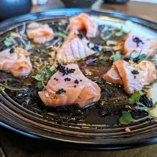 Truffle Salmon Carpaccio. $15. Seared salmon, fried onions, tobiko, truffle oil and soy mustard, apple aioli.