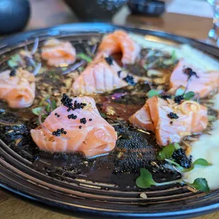 Truffle Salmon Carpaccio. $15. Seared salmon, fried onions, tobiko, truffle oil and soy mustard, apple aioli.