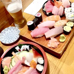 two plates of sushi and a glass of beer