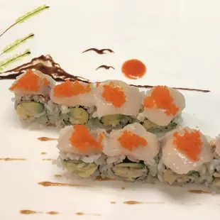 Cooked red snapper, avocado, fresh raw scallops and fish egg,  this is called Sea Spring Roll