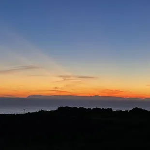 the sun setting over the ocean