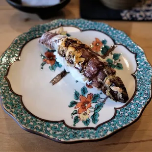 a piece of sushi on a plate