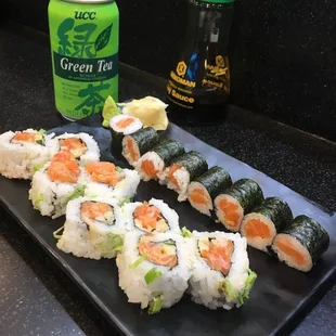 a plate of sushi and a can of green tea