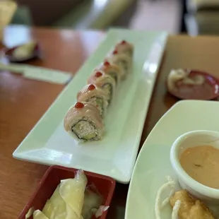 a plate of sushi and dipping sauce