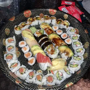 a plate of sushi and rolls