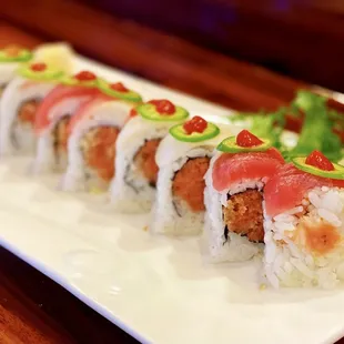 Kiss on Fire Roll: 8 pieces. Spicy tuna and crunch, topped with white tuna, tuna, and jalapeno.