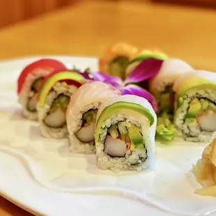 Rainbow Roll: 8 pieces. Avocado, cucumber and crab meat, with salmon, tuna, white tuna and red snapper on top.