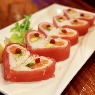 Sweet Heart Roll: 10 pieces. Spicy tuna, crab meat, and avocado, wrapped with soy bean pepper and tuna, topped with chili sauce.