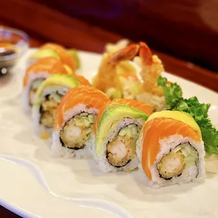 Dangon Roll: 8 pieces. Shrimp tempura and cucumber, topped with salmon, avocado, and eel sauce.