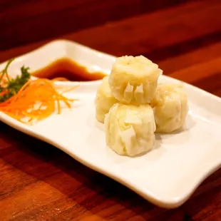 Shumai: 6 pieces. Steamed shrimp dumplings. Served with shumai sauce.