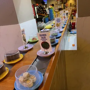 a row of plates of food on a counter