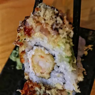 Mazey Roll - cucumber, crab meat, shrimp tempura, spicy tuna, avocado layers topped with tempura crunch and house sauce