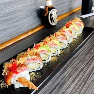 a sushi roll on a black plate