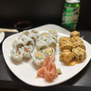 a plate of sushi and a can of soda