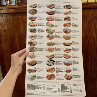 a hand holding a menu