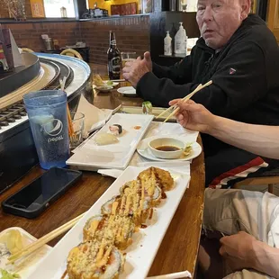 a man and a woman eating sushi