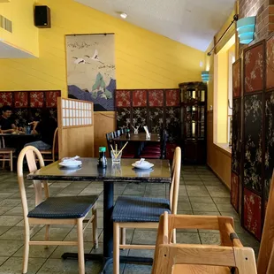 a dining area with tables and chairs
