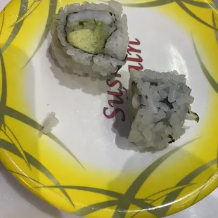 two pieces of sushi on a plate