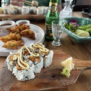 Yam tempura roll in front and umi tempura and seaweed salad in back