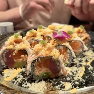 Custom roll with tuna, salmon, crab, and avocado inside + crabmeat and tempura flakes on top with fresh wasabi.