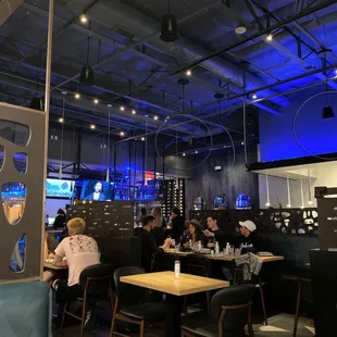 people sitting at tables in a restaurant