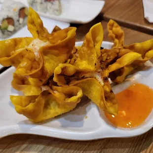 a plate of wontons with sauce