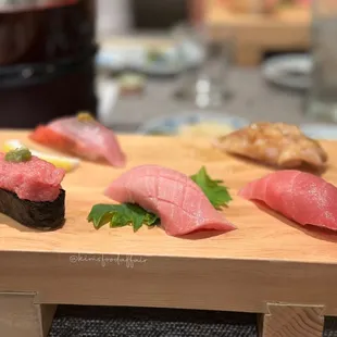 a variety of sushi on a cutting board