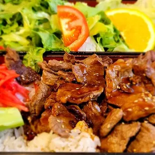 a close up of a bento box of food