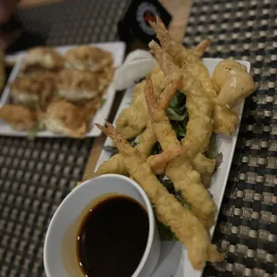 a plate of deep fried shrimp with dipping sauce