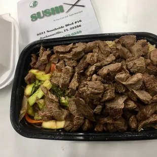 a tray of beef and vegetables