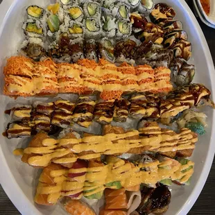a plate of sushi and rolls