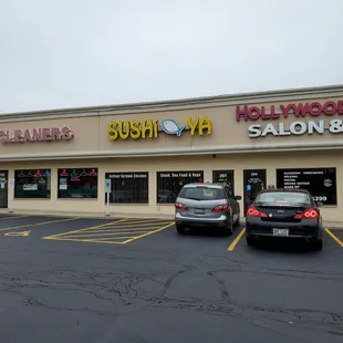 two cars parked in front of a salon and spa