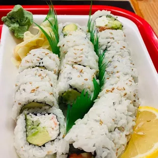 a plate of sushi rolls on a red tray