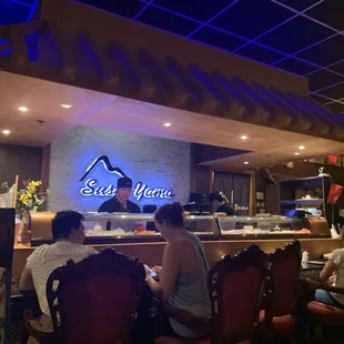 people sitting at a restaurant counter