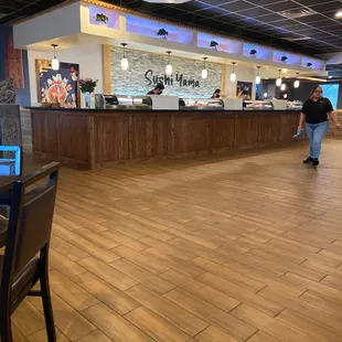a restaurant with wood flooring and a bar