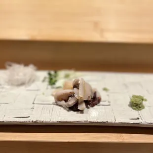 a sushi dish on a newspaper
