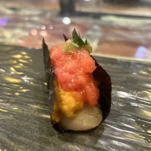 Chef special Hokkaido scallop hand roll with Uni and toro..