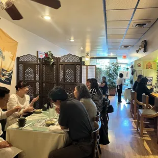 a group of people eating at a restaurant