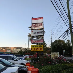 Outside. Street sign for shopping center that contains Sushi Yoshino.