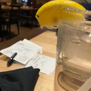 a glass of water with a slice of lemon