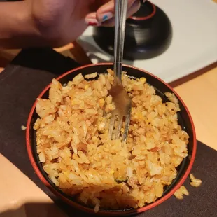 a bowl of rice with a fork in it