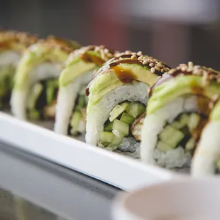 Baby Dragon Roll - Eel, Cucumber &amp; Avocado topped with Sweet Soy Sauce and Sesame Seeds
