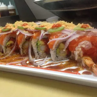 Salmon Killa!! Spicy tuna, shrimp tempura, avocado and cucumber in the inside, salmon, onions &amp; jalapenos on the outside!