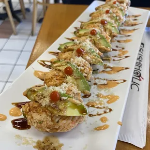 a long plate of sushi rolls