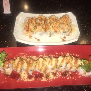 a plate of sushi and a plate of rolls