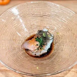 a fish dish in a glass bowl