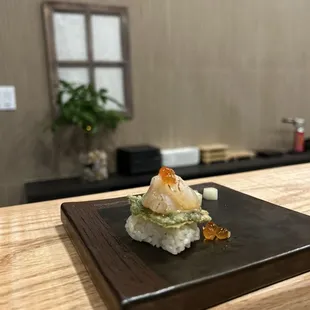 a sushi on a black plate